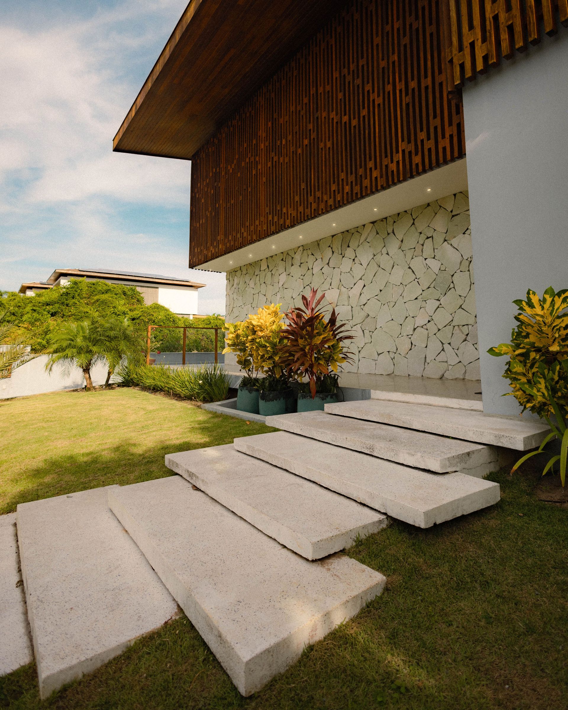 Elegant minimalist home exterior featuring a green lawn and modern architecture. Ideal for architecture enthusiasts.